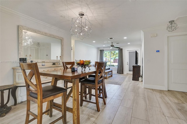 dining space featuring ceiling fan with notable chandelier, light wood-type flooring, and crown molding