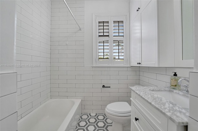 full bathroom featuring  shower combination, tile walls, toilet, vanity, and tile patterned flooring