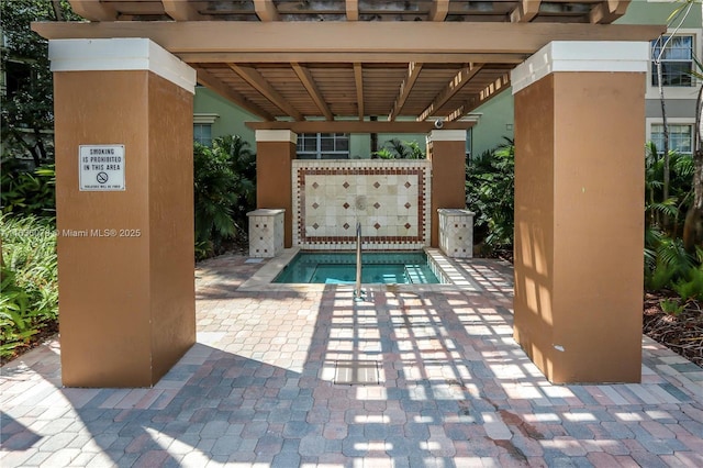 view of swimming pool featuring a patio and a community hot tub