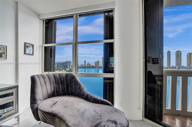 living area with a water view, hardwood / wood-style floors, and plenty of natural light