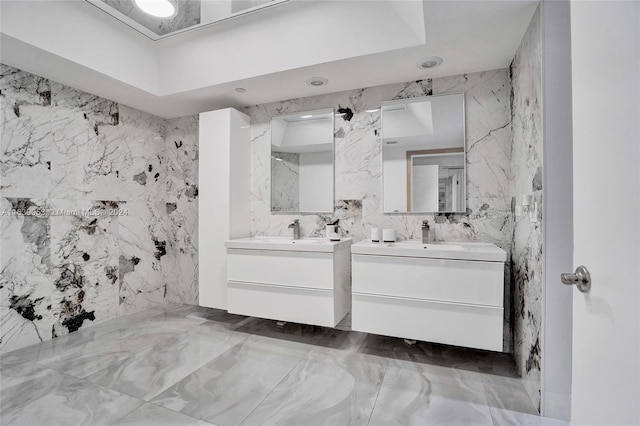 bathroom featuring vanity and tile walls