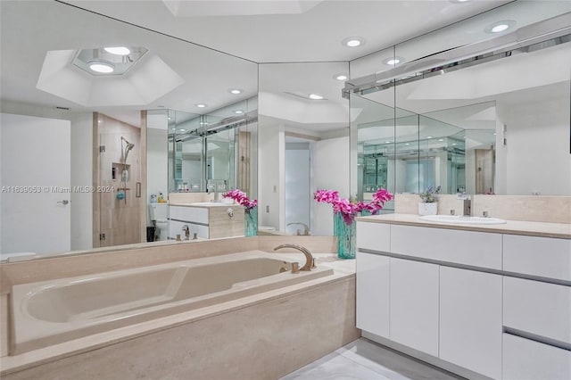 bathroom featuring vanity and shower with separate bathtub