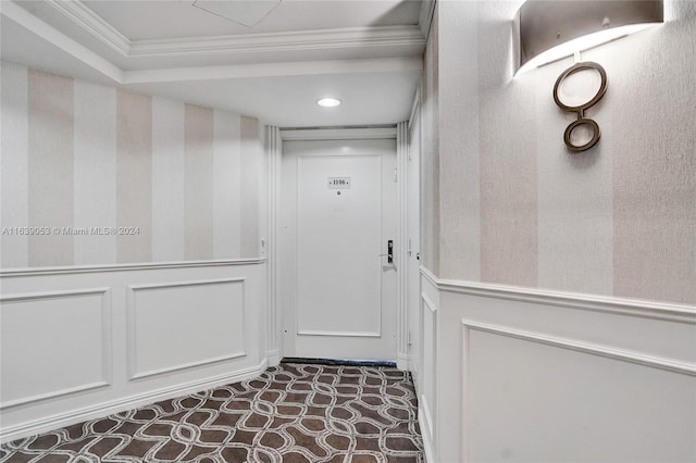 interior space with crown molding and dark colored carpet