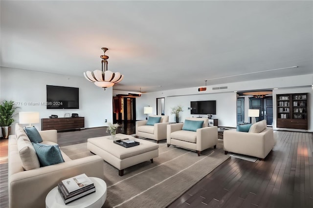 living room featuring a chandelier and hardwood / wood-style flooring