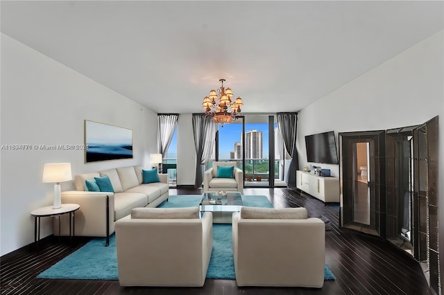 living room with an inviting chandelier and dark hardwood / wood-style flooring