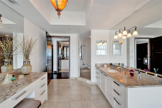 bathroom featuring vanity, a tray ceiling, wood-type flooring, and walk in shower