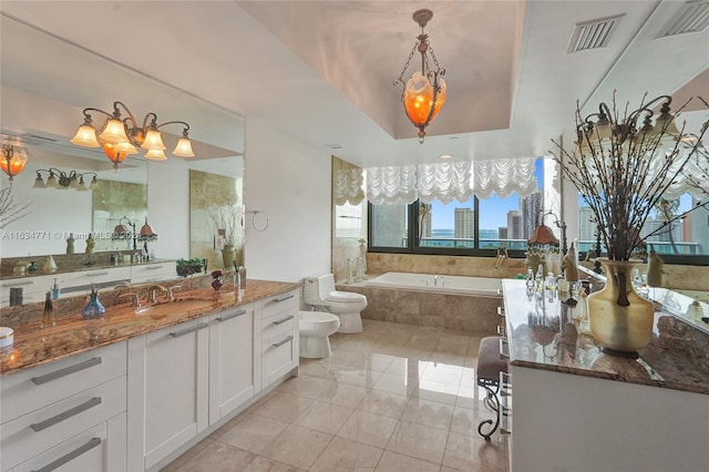 bathroom featuring a relaxing tiled tub, toilet, tile patterned floors, vanity, and a bidet