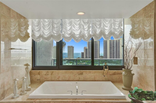 bathroom with tile walls and tiled tub