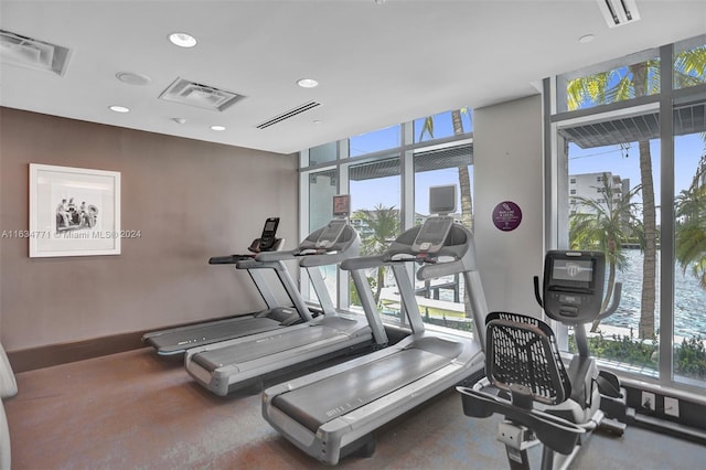 exercise room with a water view