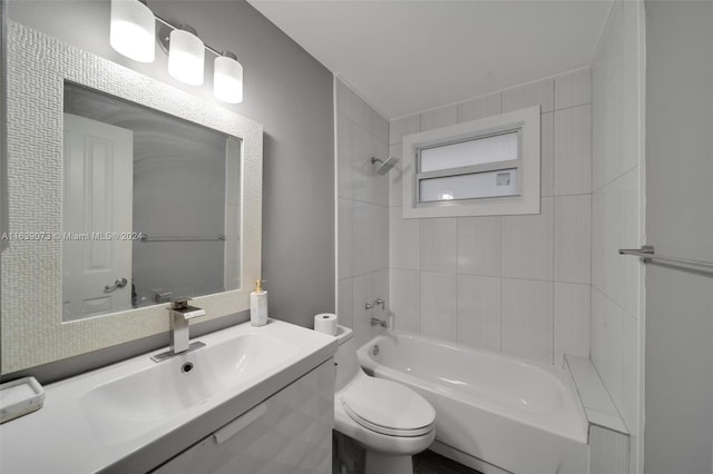 full bathroom with tiled shower / bath combo, vanity, and toilet