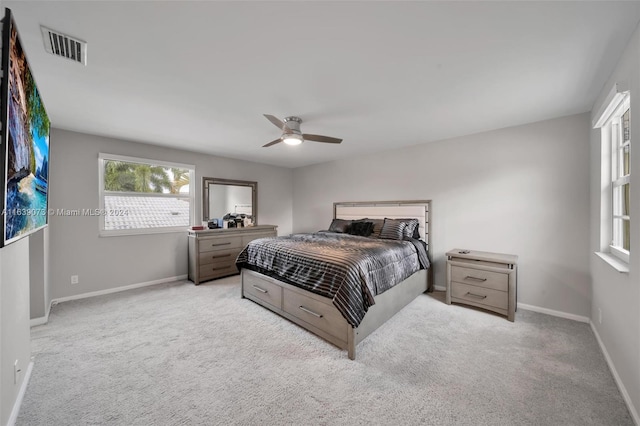 bedroom featuring light carpet and ceiling fan