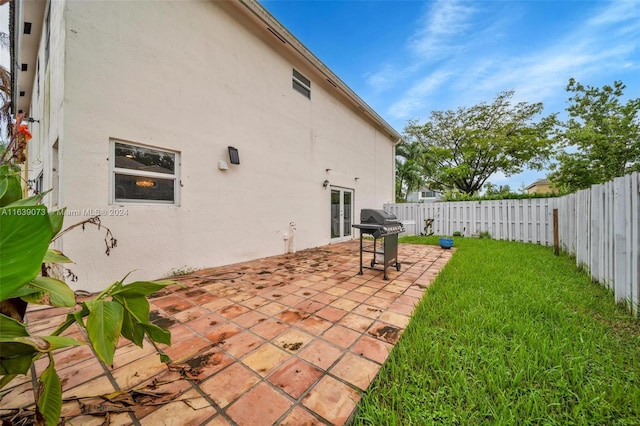 exterior space with a lawn and a patio