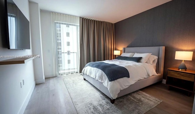 bedroom featuring wood-type flooring and multiple windows