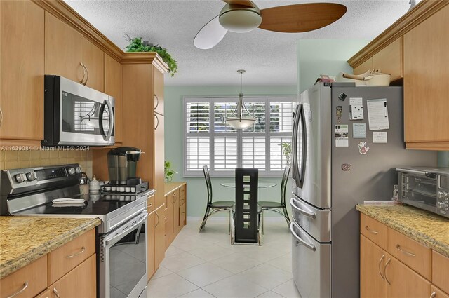 kitchen with light tile patterned floors, a toaster, decorative backsplash, appliances with stainless steel finishes, and a textured ceiling