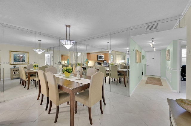 dining space featuring a chandelier and light tile patterned floors