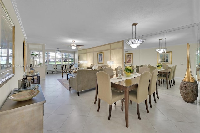 dining room with ceiling fan, light tile patterned flooring, and crown molding