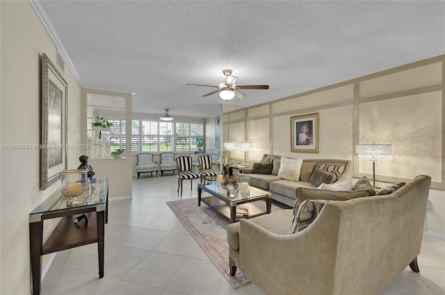 living room featuring ceiling fan, light tile patterned flooring, a textured ceiling, and crown molding