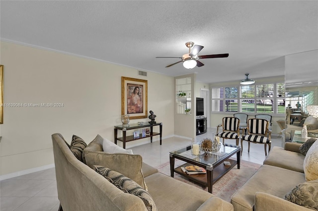 tiled living room with ceiling fan, a textured ceiling, and crown molding