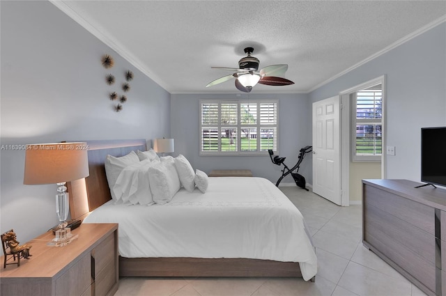 tiled bedroom with a textured ceiling, ornamental molding, and ceiling fan