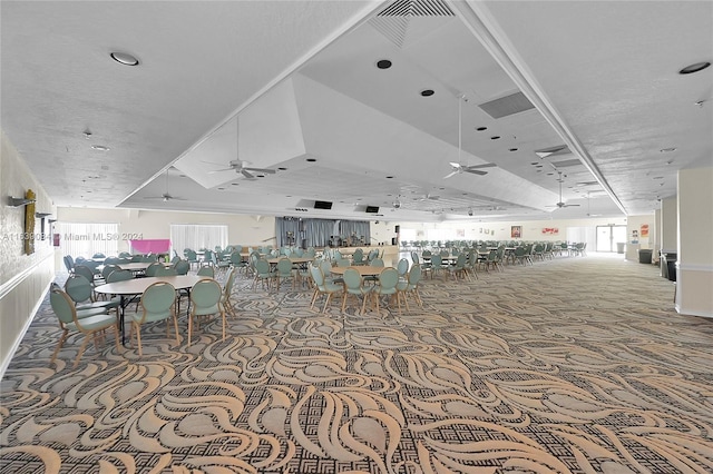 interior space with ceiling fan and carpet flooring