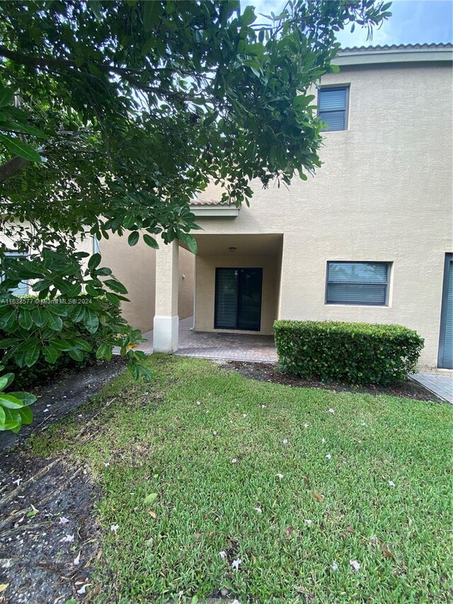 doorway to property with a yard