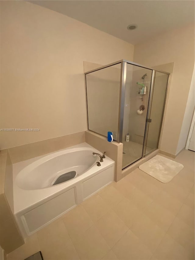 bathroom featuring shower with separate bathtub and tile patterned flooring