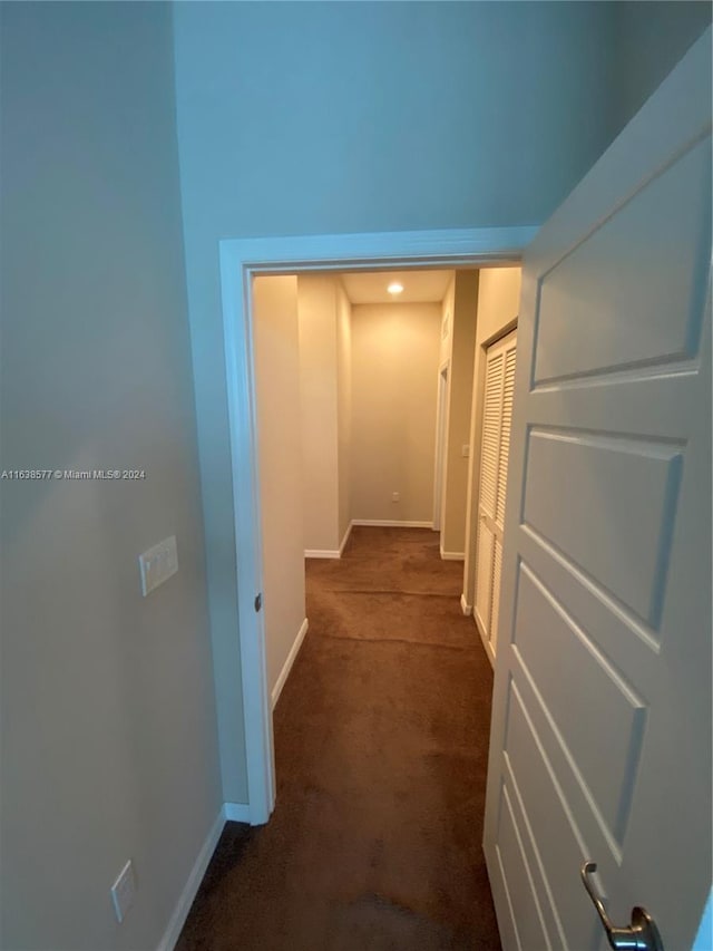 corridor with dark colored carpet