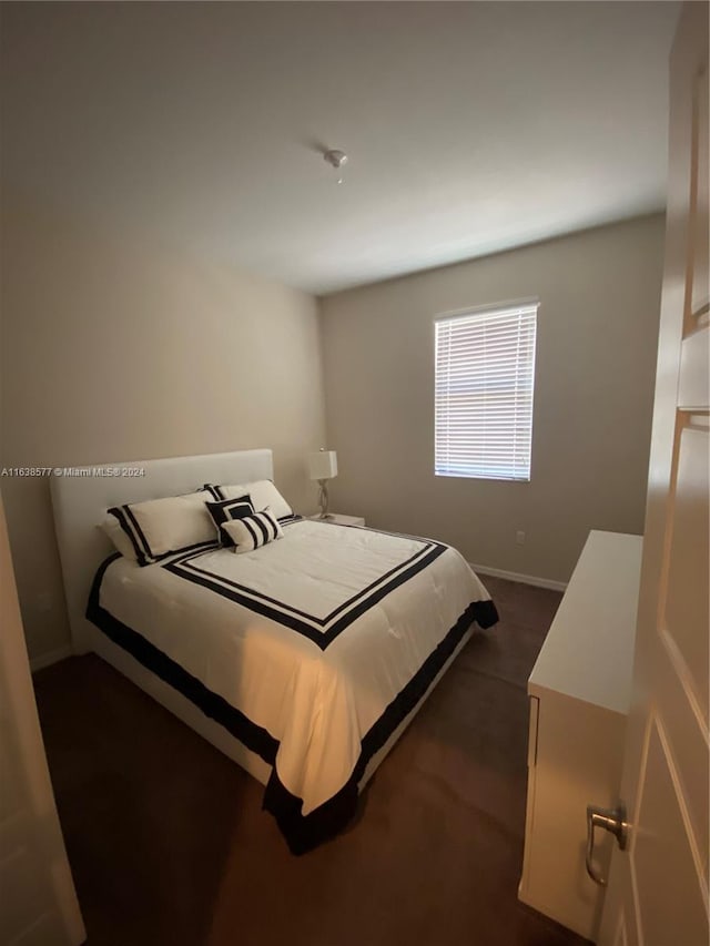 bedroom featuring dark colored carpet