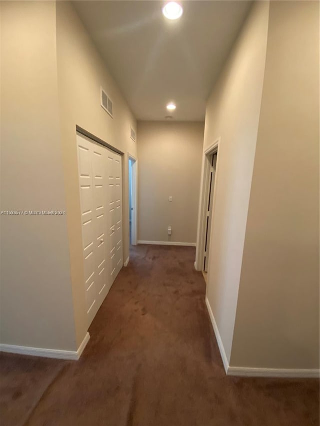 hall featuring carpet flooring