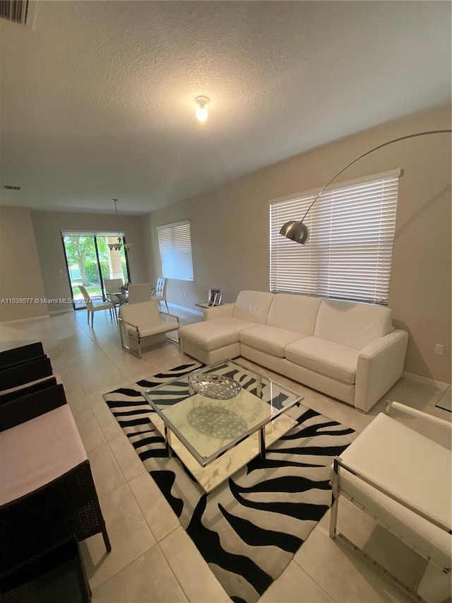 living room with light tile patterned floors and a textured ceiling