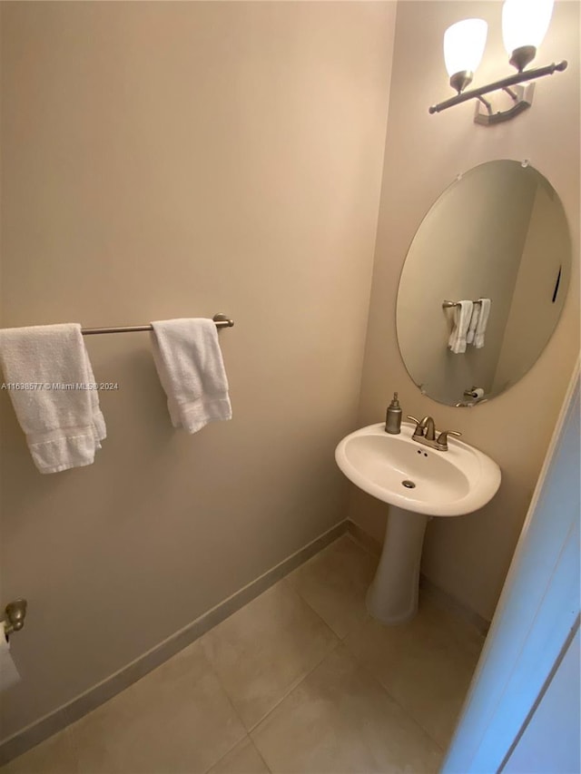 bathroom featuring a chandelier and tile patterned flooring