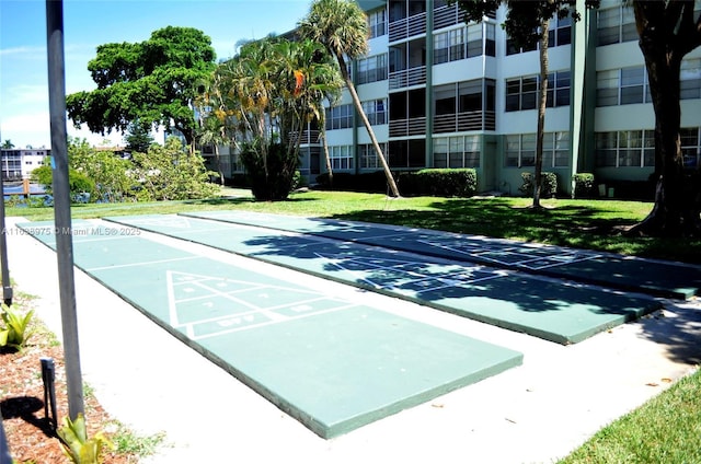 view of home's community featuring a lawn