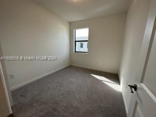 unfurnished room with carpet flooring