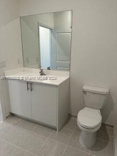 bathroom featuring tile patterned floors, vanity, and toilet