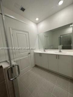 bathroom with dual bowl vanity and tile patterned flooring