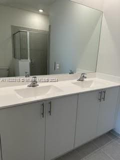 bathroom featuring double vanity, toilet, and tile patterned floors