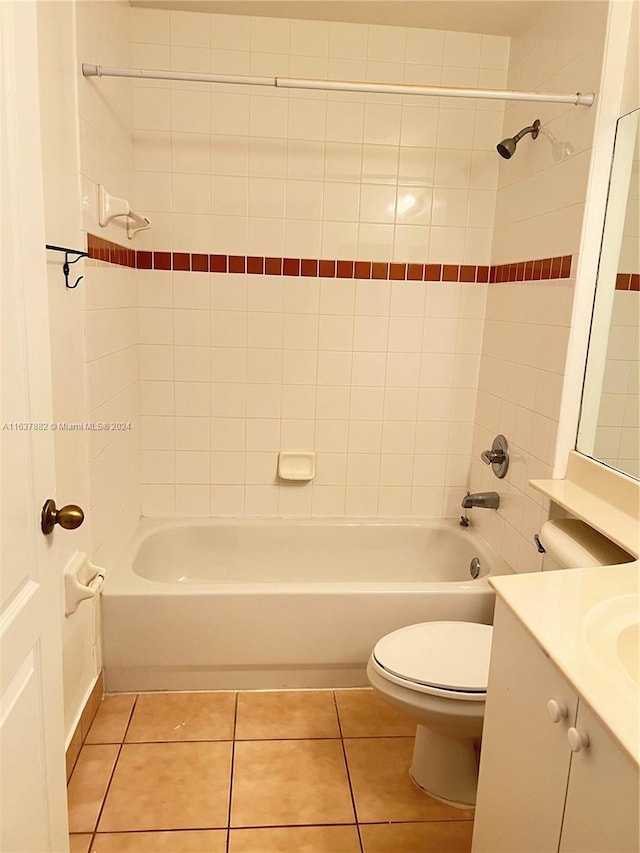 full bathroom featuring tile patterned floors, vanity, toilet, and tiled shower / bath