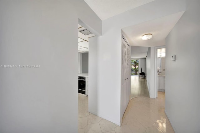 hall featuring light tile patterned floors