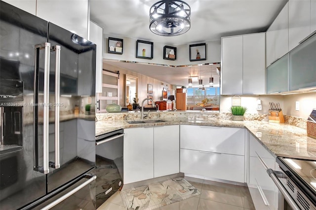 kitchen featuring sink, white cabinets, and black appliances