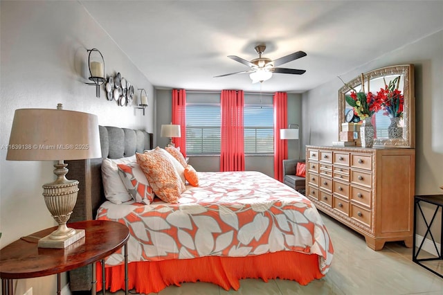 bedroom with ceiling fan and light tile patterned floors