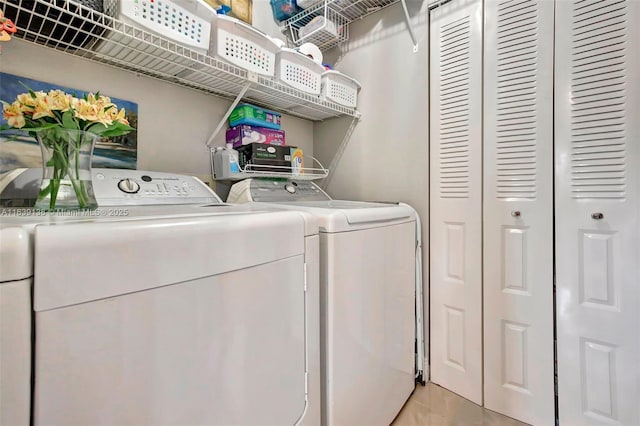 clothes washing area featuring separate washer and dryer and light tile patterned floors