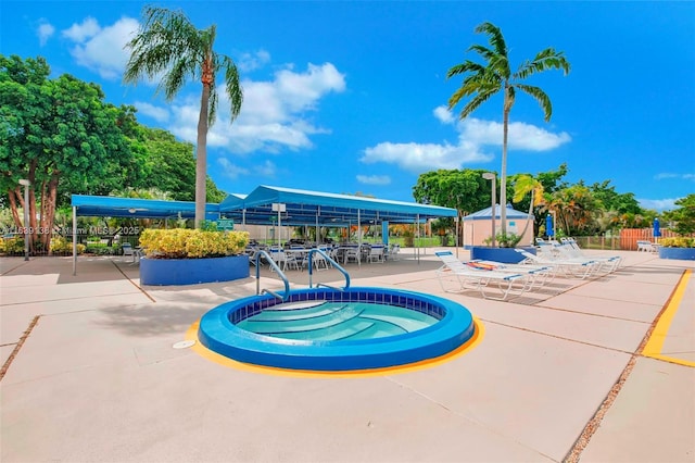 view of swimming pool with a community hot tub and a patio area