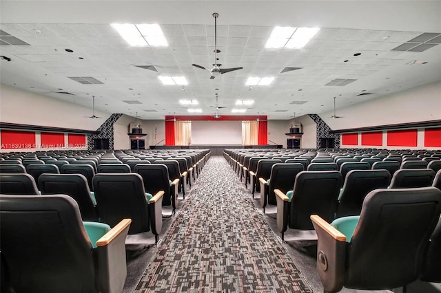 home theater room featuring carpet floors, a drop ceiling, and ceiling fan