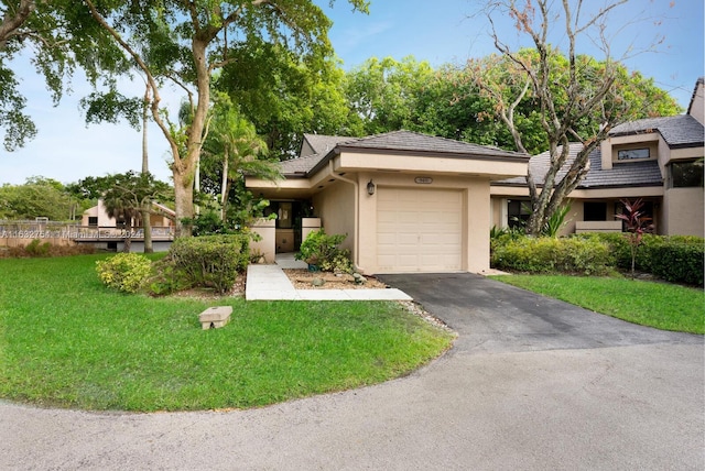 view of front of property with a front lawn and a garage