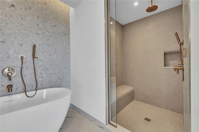 full bathroom with a freestanding tub and a tile shower