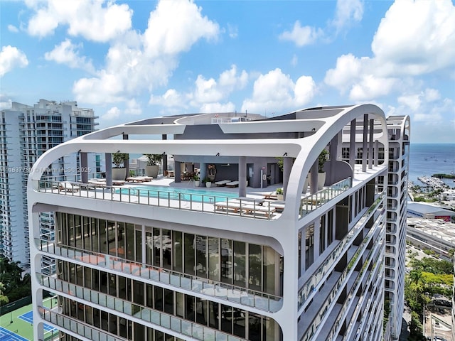 exterior space with a community pool and a city view