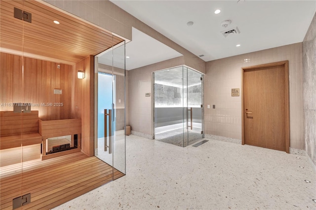 view of sauna / steam room with recessed lighting and speckled floor