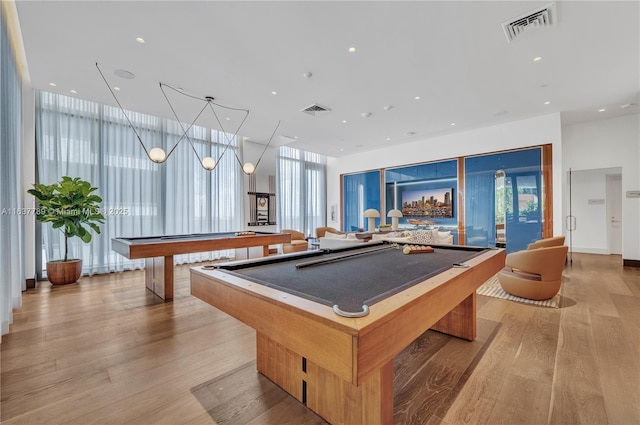 rec room featuring expansive windows, billiards, and light hardwood / wood-style flooring