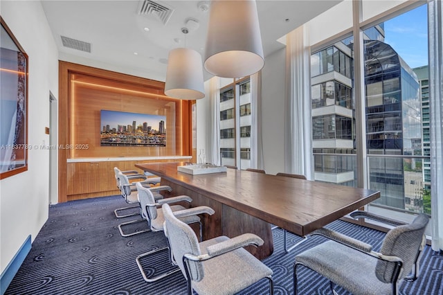 dining room featuring bar area and plenty of natural light