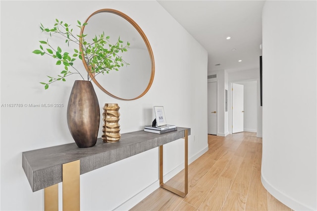 corridor with recessed lighting, light wood-style floors, and baseboards